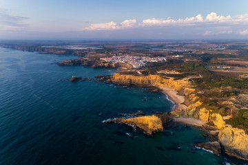 Aerial view of the beautiful Alteirinhos Beach at Zambujeira do Mar, Alentejo, at sunset.