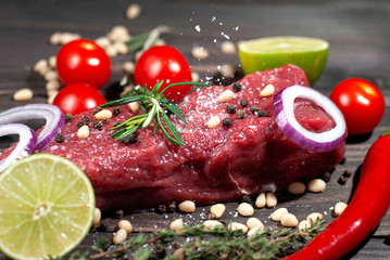 Juicy piece of meat sprinkled with salt with lime and spices tomatoes