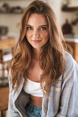 Optimistic happy pleased redhead woman indoors at home.