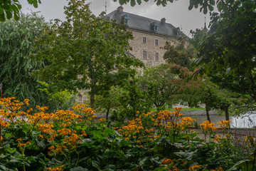 Fragment of Orebro castle with flowers and trees. Castle view from park side. Travel photo, background or illustration.