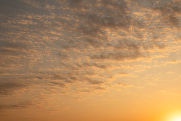 Fototapeta na wymiar Yellow-orange clouds in the sky during sunrise