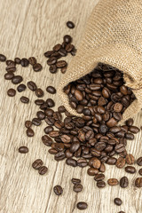 coffee bean bag and coffee beans on wooden table. 