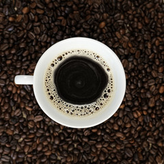 Black coffee, Espresso in a cup of coffee and coffee beans background.