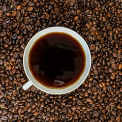 Black coffee, Espresso in a cup of coffee and coffee beans background.