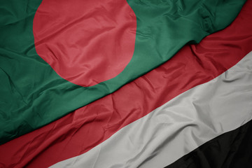 waving colorful flag of yemen and national flag of bangladesh.