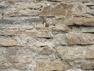 A fragment of an old ruined stone wall.
