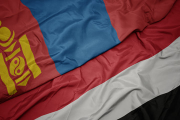 waving colorful flag of yemen and national flag of mongolia.