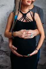 Pregnant and pregnancy. Young couple expecting baby standing together indoors