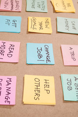 new year goals or resolutions - colorful sticky notes on a Notepad with coffee Cup.