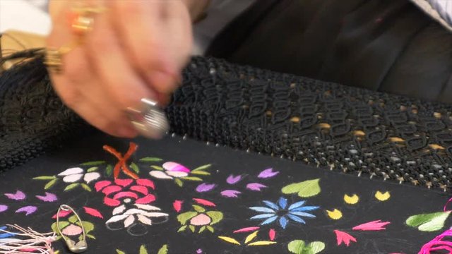 Lady embroidering a typical shawl in Sardinia, italy