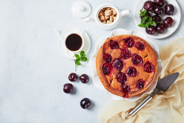 plum torte on a white platter, flat lay