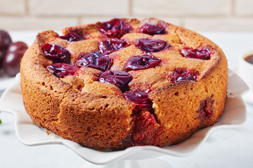 close-up of a whole red plum torte