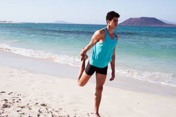 Man holds his leg behind him as he exercises