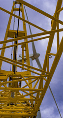 Industrial background. Wind turbine and mobile crane 