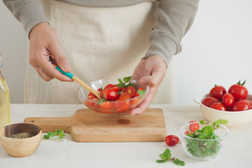 Fresh delicious salad with tomatoes. Doing fresh green salad