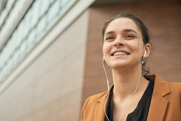 Young woman with earphones talking outdoor