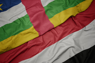 waving colorful flag of yemen and national flag of central african republic.