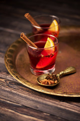 Mulled wine with spices in glasses on a wooden table. Winter CHRISTMAS HOT DRINK
