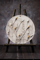 botanical bas-relief flowers made of clay and gypsum in workshop