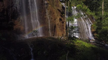 Man and woman together walks in canyon along the river through the waterfall  Goa Tetes, Java island, Indonesia