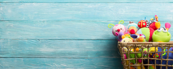 Toys collection in box on abstract wooden background. Donatation. Copy space for text