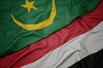 waving colorful flag of yemen and national flag of mauritania.