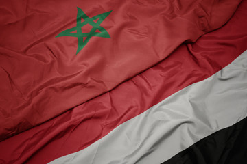 waving colorful flag of yemen and national flag of morocco.