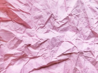 Fototapeta premium Crumpled pink paper pattern background. 