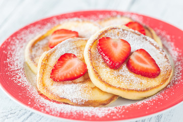 Portion of ricotta fritters with fresh strawberries