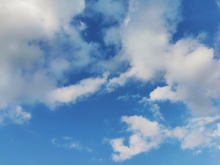 The blue sky with white clouds floating on space.   