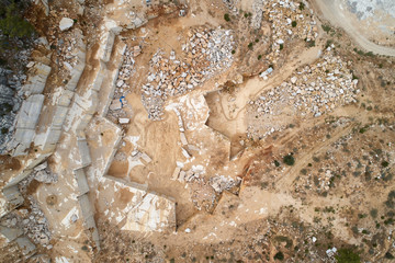 Marble quarry ledges. Terraces of cutted stone material. Aerial view.