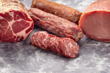 Variety of meat products including ham and sausages.