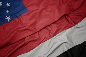 waving colorful flag of yemen and national flag of Samoa .