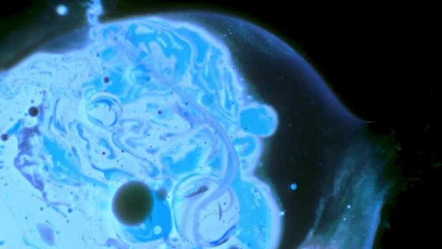 An abstract blue planet floats around when the outer edge explodes slowly.