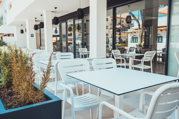 some white tables in a restaurant