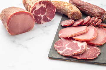 Display of a variety of seasoned ham and smoked sausages