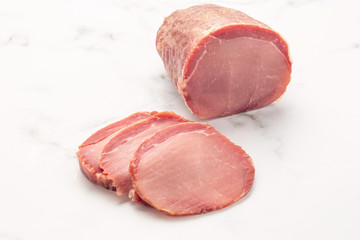 Tasty sliced ham on white stone