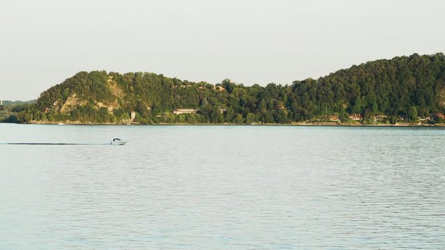Small speedboat on Lake Maggiore perfectly tracked by camera with navigating at full speed