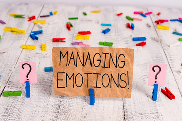 Text sign showing Managing Emotions. Business photo text ability be open to feelings and modulate them in oneself Scribbled and crumbling sheet with paper clips placed on the wooden table
