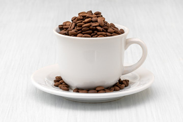 Cup full of coffee beans