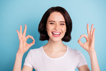 Close-up portrait of her she nice attractive cheerful cheery glad positive girl showing two ok-sign ad advert good solution isolated on bright vivid shine vibrant blue turquoise color background