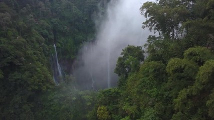 Aerial : Fly cam open view to Tumpak Sewu waterfall , Java island, Indonesia