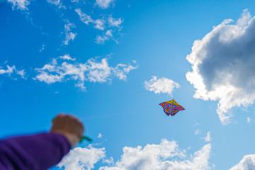 womans handing the rope while playing kite in the sky, enjoy lifestyle in freedom.