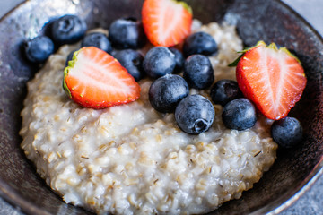 Oatmeal with strawberry and blueberry closeup