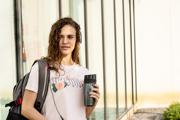 Teenager student On College with mobile music  and drink