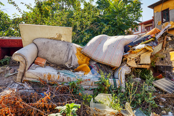 Abandoned old sofa and bed on the street of the suburb
