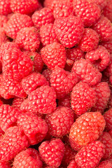 Berry background of ripe garden raspberry. Healthy food. Close-up view