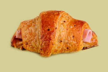 Croissant hot dog on yellow board.