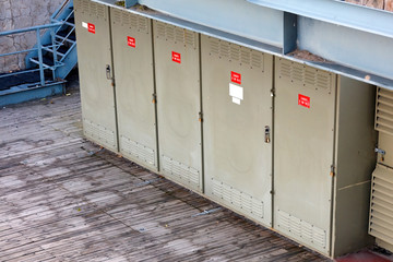 Electricity power transformer substation boxes aligned in an outdoor facility