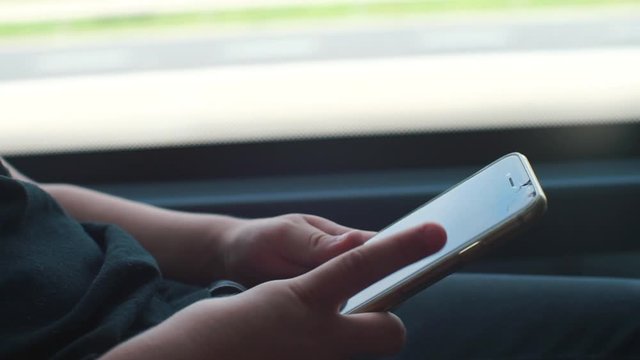 child uses a smartphone in a public transport train